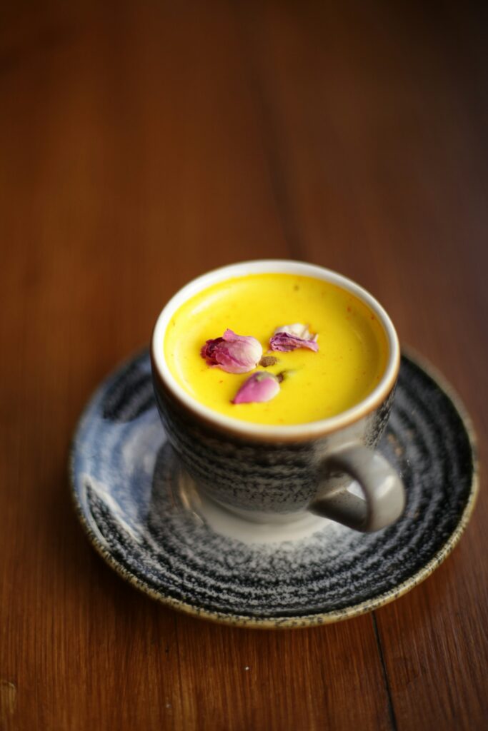 Golden turmeric milk in a ceramic cup, a daily wellness drink made with turmeric powder