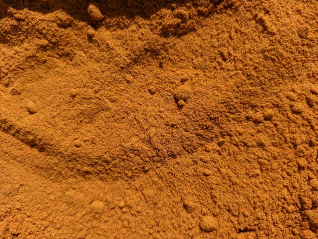 Close-up texture of golden orange turmeric powder